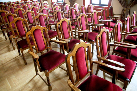 Interior of a theater of arts without people. Auditorium with empty red seats chairs. Soft depth of...