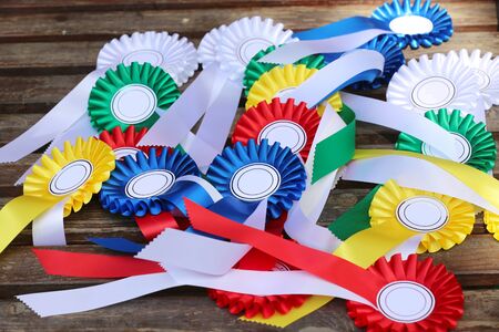Equestrian sport trophys badges rosettes on table at equestrian eventの写真素材
