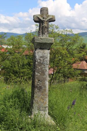 Picture of a many hundred years old stone cross in an old cemeteryの写真素材