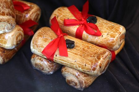 Homemade poppy seeds or walnut roll cakes aka beigli or bejgli for sale on christmas fair 