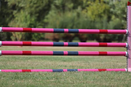 Wooden barriers for jumping horses as a background. Colorful photo of equestrian obstacles. Colorful barriers on the ground for jumping horses and riders at riding school as a background.Obstacles for horses in a riding schoolの写真素材