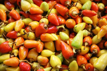  Pile of fresh ripe chili peppers for sale in vegetables market as background