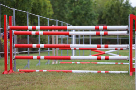 Colorful image of show jumping poles at an open air show jumping arena. Obstacles poles barriers for jumping horses as a backgroundの写真素材