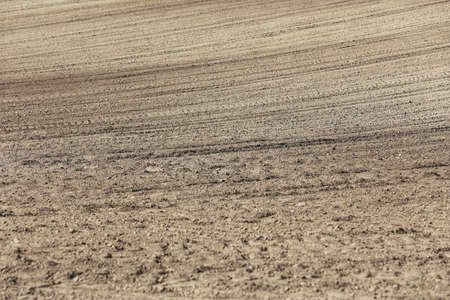 Landscape agricultural land in slope recently plowed for the crop