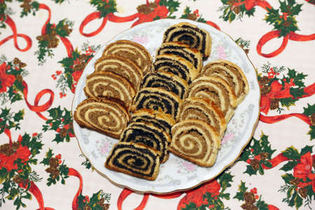 Homemade poppy seeds or walnut roll cakes aka lopli or bejgli slices like a winged angel on a plate....