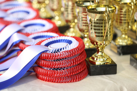 Pile of horse sport trophies rosettes at equestrian event at summertime outdoorsの写真素材