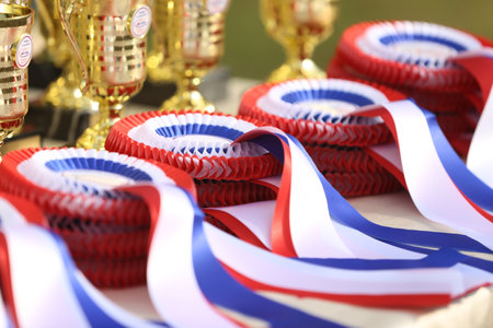 Pile of horse sport trophies rosettes at equestrian event at summertime outdoorsの写真素材