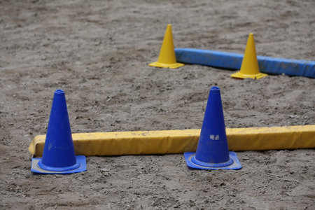 Obstacles and buoys in the sand in an empty equestrian centerの写真素材