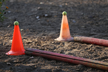 Obstacles and buoys in the sand in an empty equestrian center