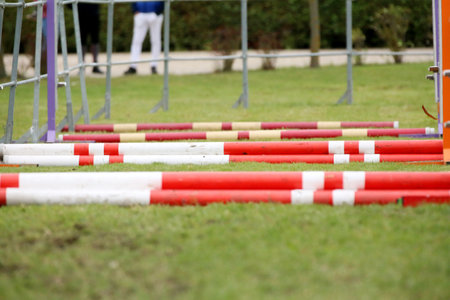 Show jumping poles obstacles, barriers, waiting for riders on show jumping training. Horse obstacle...