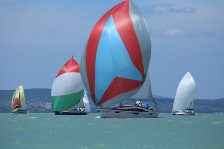 Lake of Balaton, Hungary Europe. 06 July 2023: Group of sailboats sail in windy weather in the turquoise waters of the Lake Balaton Plattensee during 55th Long Distance Blue Ribbon aka KÃ©kszalagのeditorial素材
