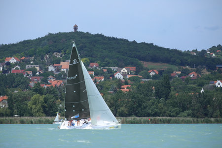 Lake of Balaton, Hungary Europe. 06 July 2023: Sailboat sail in windy weather in the turquoise waters of the Lake Balaton Plattensee during 55th Long Distance Blue Ribbon aka Kekszalagのeditorial素材