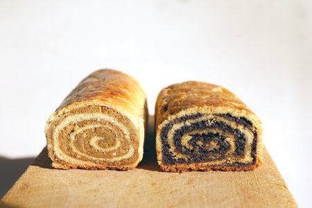 Close Up of Walnut and Poppy Seeds Rolls. Traditional Hungarian Homemade Christmas Beigli or Beigli Cake on Wooden Board. Holiday Backgroundの写真素材
