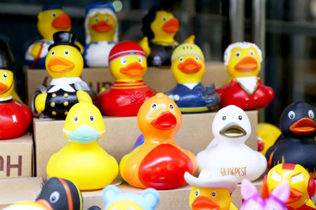 Rubber Duckies in row for sale. Large image. Colorful toys. Many colorful rubber duck toys in various outfits on sale. Rubber ducks are a popular toy around the worldの写真素材