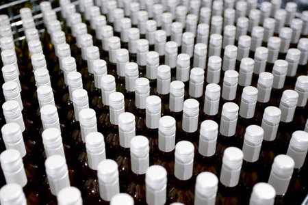 Bottles in a row at wine cellar. Stacked up wine bottles in the cellar. Shallow DOFの写真素材