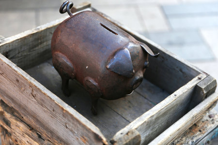 Closeup of a wrought iron piggy bank for saving coins. Funny investment, business, finance and saving money concept.の写真素材