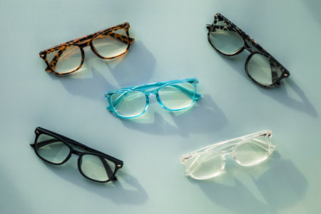 An Assortment of Blue Light Blocking Reading Glasses on Light Blue Solid Background