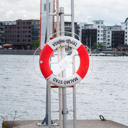 MalmÃ¶, Sweden - May 17, 2020: A lifebuoy for safety in the old Cementa harbor in Limhamnのeditorial素材