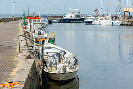 Malmo, Sweden- June 28, 2020: Small fishing boats in a marina in Scania, Southern Sweden. The fishing business is not so affected by the coronavirus pandemic.のeditorial素材