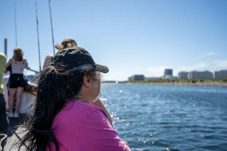 Malmo, Sweden - August 6, 2020: A middle-aged Asian woman on a boat trip a hot summer day. Bright...