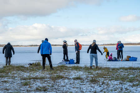 January 31, 2021 - Lund, Sweden: People skating on the ice of Lake Krankesjon. This winter is unusually cold, many take the opportunity to practise outdoor activities during the coronavirus pandemicのeditorial素材