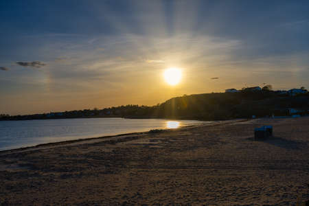 A beautiful orange sunset over an ocean bay. Thee sun reflects in the water. Picture from the Swedish west coastの写真素材
