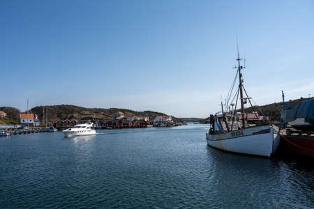 April 17, 2021 - Hamburgsund, Sweden: A picturesque fishing village on the Swedish West coast. Traditional red sea huts and a blue sky in the backgroundのeditorial素材