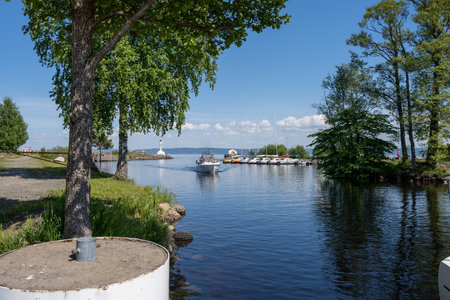 June 5, 2021 - Habo, Sweden: The inlet to Domsand marina, Lake Vattern a hot summer day. Picture taken from the shade of pine trees at Domsand beach, Haboのeditorial素材