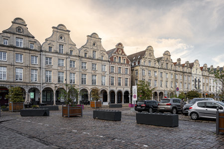 Arras, France - November 4, 2021: Town square of Arras, France. UNESCO World Heritage Site. House facades in Flemish style against a dark grey skyのeditorial素材