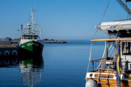 June 26, 2021 - Boda Harbour: Fishing boats in beautiful sunset light. These fine days have brought...
