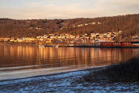 Beautiful winter sunset at a lake beach and a blue sky in the background