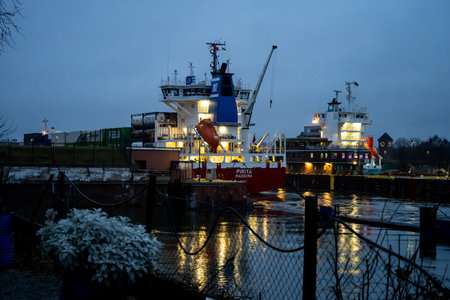 Kiel, Germany - February 22, 2022: A maritime vessel in nighttime is entering the Kiel Canal from the Baltic Sea. The Kiel Canal links the Baltic Sea with the North Seaのeditorial素材