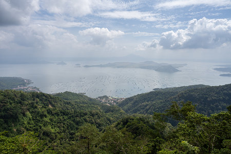 A view over Lake Taal and the Taal Volcano, from Tagaytay City, the Philippines. Haze in the skyの写真素材