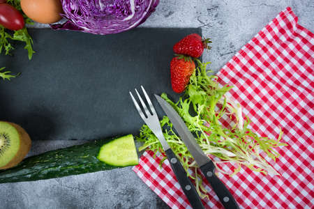 Vegetables and fruits on a dark rustic table. Healthy vegetarian food.