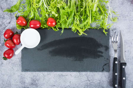 knife and fork at napkin on wooden backgroundの写真素材