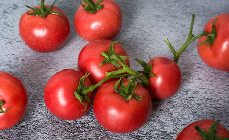 Fresh tomatoes in a plate on a dark background. Harvesting tomatoes. Top viewの写真素材
