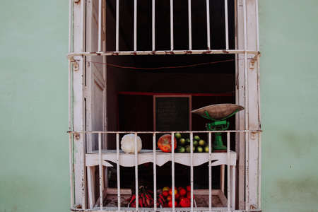 Green grocery selling fresh fruit and vegetables, stall showing a scale, cauliflower, tomatos,...