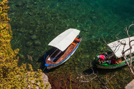 Boat moored to a rock, clear water of Lake Ohrid on a summer day, City of Ohrid, Republic of North...