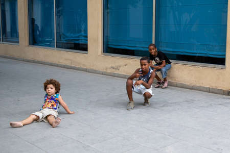 Havana / Cuba - 04.16.2015: African and Caucasian Cuban kids playing together on the streetのeditorial素材
