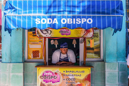 Havana / Cuba - 04.15.2015: A Cuban man selling ice cream in a shop, thinking deep thoughts