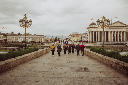 Skopje / North Macedonia, May 12 2019: The Archaeological Museum of Macedonia and Macedonian people walking on the Stone Bridge; a main historical tourist attraction that originates from the Ottoman periodのeditorial素材