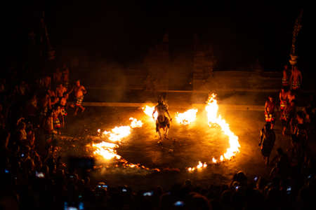 Bali - Indonesia - 10.21.2015: Kecak dancers performing the Fire Dance in the Pura Luhur Uluwatu amphitheater, Uluwatu Temple a Balinese Hindu sea temple on the hillのeditorial素材
