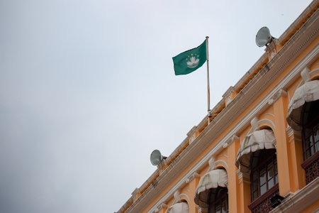 National flag of the Republic of Kazakhstan on the roof of the buildingの写真素材
