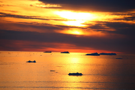 Icebergs in the ocean at sunset. Global warming concept.の写真素材