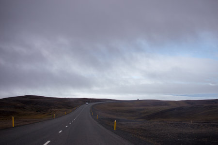 Road in Iceland with cloudy sky, selective focus on the road.の写真素材