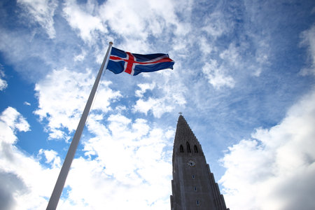 Flag of Iceland waving in front of Skyscraper in Reykjavik, Icelandの写真素材