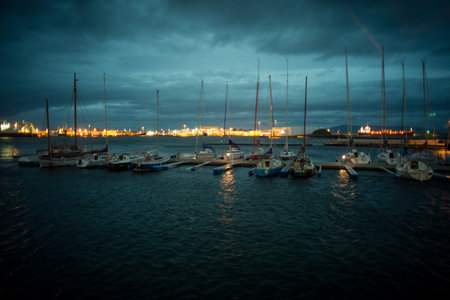 Boats and yachts moored in the harbor at night