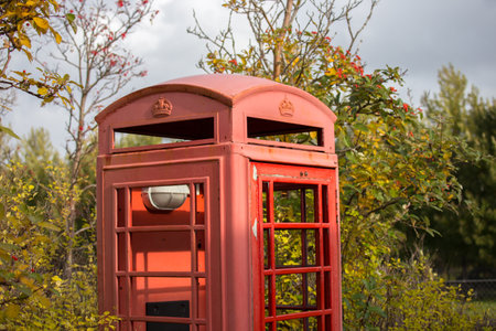 Red telephone box in a public park in London, England, UK