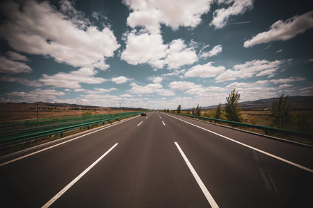 Empty asphalt road with blue sky and white clouds - retro vintage effectの写真素材