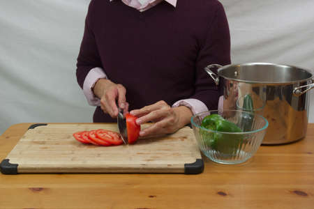 man cutting tomatoの写真素材